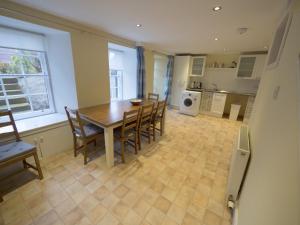 a kitchen and dining room with a table and chairs at The Gallery Flat, 4 Tannage Brae in Kirriemuir