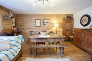 a living room with a table and a couch at Hotel Funivia in Courmayeur