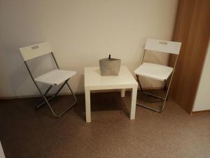 two chairs and a table with a plant on top of it at Holiday B&B 1984 in Bari +10 photos