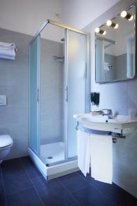 a bathroom with a glass shower and a sink at Garibaldi Palace in Milan