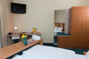 a hotel room with a bed and a mirror at Straelener Hof in Straelen +57 photos