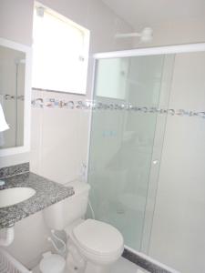 a bathroom with a shower and a toilet and a sink at Estrela Azul Guest House Búzios in Búzios