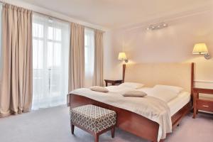 En eller flere senger på et rom på Sun Palace Wellness Hotel