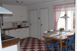 uma cozinha com uma mesa e cadeiras numa cozinha em Hermanslycke Bed & Breakfast em Tvååker