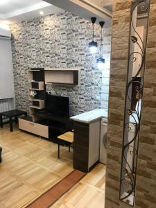 a living room with a stone wall and a counter at Kaskad apartment and Tours in Yerevan