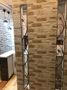 una pared de ladrillo con dos espejos delante en Kaskad apartment and Tours, en Ereván