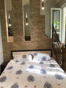 a bed with blue and white sheets and pillows at Kaskad apartment and Tours in Yerevan