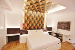 A bed or beds in a room at Albergo Abruzzi