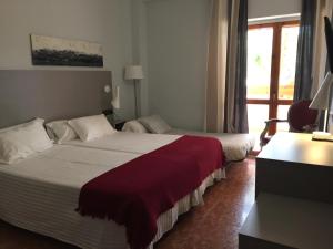 Postel nebo postele na pokoji v ubytování Hotel Valjunco