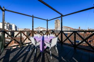 una mesa en un balcón con vistas a la ciudad en Rialto Apartment en Venecia