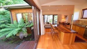 a kitchen and living room with a view of a house at Santosha Glade near the Everglades in Leura
