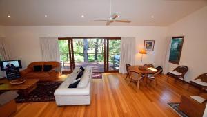 a living room with a couch and a table at Santosha Glade near the Everglades in Leura