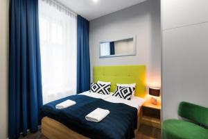 Posteľ alebo postele v izbe v ubytovaní Kings City - Sławkowska Apartments