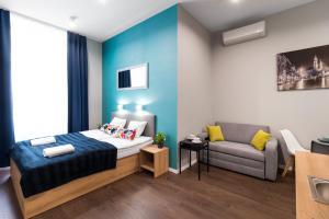 クラクフにあるKings City - Sławkowska Apartmentsの小さなベッドルーム(ベッド1台、ソファ付)