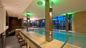 a large swimming pool in a building with a building at Apartmány Sabai Dee in Stará Lesná