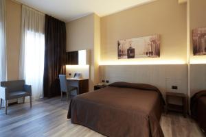a hotel room with a bed and a desk at Garibaldi Palace in Milan