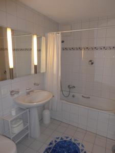 a bathroom with a sink and a shower and a toilet at Haus Gaschür in Bad Ragaz