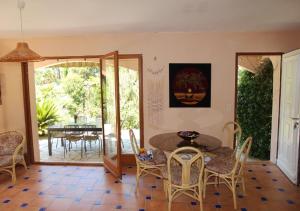 a dining room with a table and chairs at Andre in Porto-Vecchio