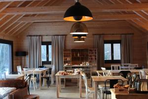 a dining room with tables and chairs and windows at Piedrafita Mountain in Piedrafita de Jaca +48 photos