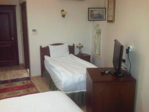 
A bed or beds in a room at Basileus Hotel
