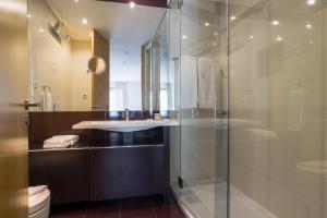 a bathroom with a glass shower and a sink at Pretty Porto Apartment by SOULSHARING.PORTO in Porto +33 photos