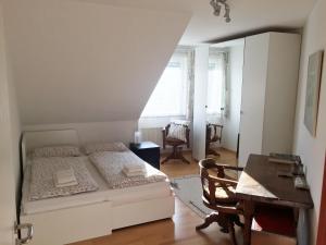 a bedroom with a bed and a desk and a table at Apartment Flair in Uni Nähe in Lübeck