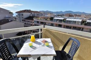 a table with two drinks on top of a balcony at Residhotel Cannes Festival in Cannes