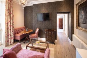 a living room with a couch and a table at Beech House - Urban Apartments in Bristol