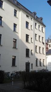 a white building with bikes parked in front of it at Bastians Herberge in Leipzig