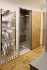 a bathroom with a shower and a glass door at Apartmán Jestřáb č. 23 - u kabinky in Janske Lazne