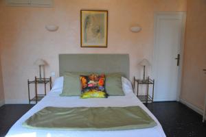a bedroom with a bed with a pillow on it at Villa Valflor chambres d'hôtes et appartements in Marseille
