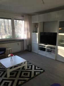 a living room with a tv and a coffee table at Wilschenbruch in Lüneburg