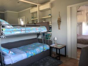 a bedroom with two bunk beds and a mirror at Grimaldines - Villa in Cagnes-sur-Mer