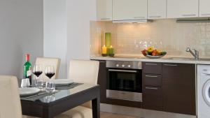 a kitchen with a table with glasses of wine at Escala Hotel & Suites in Budapest