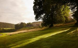 a large green field with a building in the background at Shrigley Hall Hotel in Macclesfield