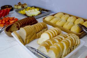 a buffet of bread and pastries on a table at Hotel Guarany in Canoinhas
