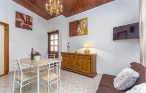 a dining room with a table and a tv at Apartment Dorijana in Poreč