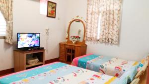 Posteľ alebo postele v izbe v ubytovaní Yilan Xiang Feng Homestay