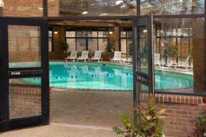 a swimming pool with chairs in a building at Turkey Run Inn & Cabins in Marshall