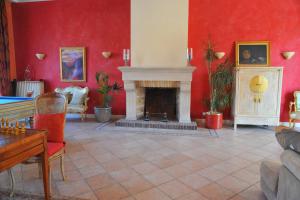 a living room with a fireplace and red walls at Villa Valflor chambres d'hôtes et appartements in Marseille