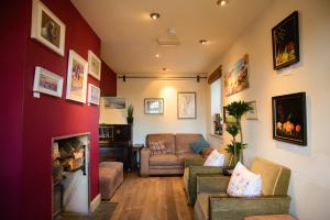 a living room with a couch and a fireplace at The Kings Arms in Sherborne