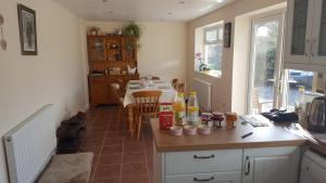 a kitchen with a table with bottles on it at Brookside Cottage in Okehampton