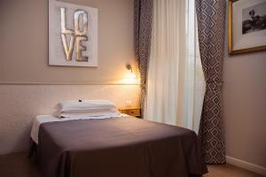 a hotel room with a bed with a novy sign on it at Albergo Al Viale in Trieste