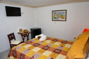 Postel nebo postele na pokoji v ubytování Hotel Los Jardines