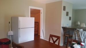 a kitchen with a white refrigerator and a table at walker's retreat in Durham Subdivision