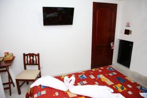 Postel nebo postele na pokoji v ubytování Hotel Los Jardines