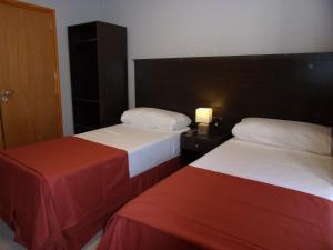 Una cama o camas en una habitación de Demetrio Hotel Apart
