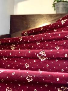 a pile of red fabric with flowers on it at Familia in Český Krumlov +59 photos