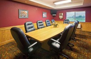 a conference room with a wooden table and chairs at AmericInn by Wyndham Anamosa in Anamosa