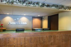 a lobby of a american inn with a sign on the wall at AmericInn by Wyndham Minocqua in Minocqua +21 photos